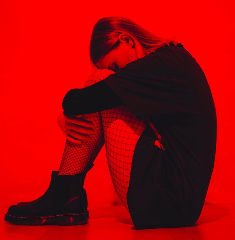 woman in black coat and black and white checkered pants