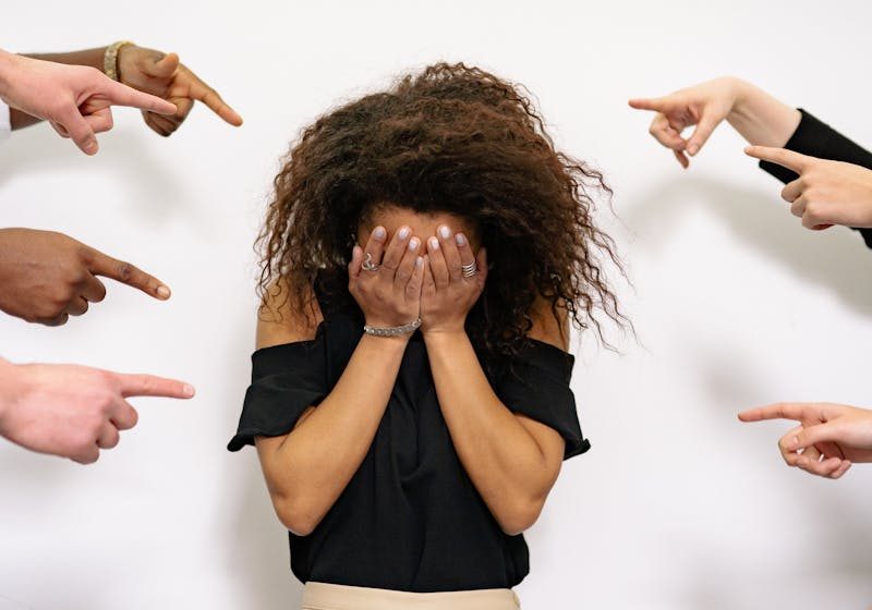 People Pointing Fingers at a Stressed Woman